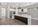 Modern kitchen featuring stainless steel appliances, white cabinets, a large island, and stylish backsplash at 422 E Kaibab Pl, Chandler, AZ 85249