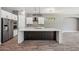 Bright kitchen featuring a large island with brickwork and white cabinets, stainless appliances, and modern lighting at 422 E Kaibab Pl, Chandler, AZ 85249