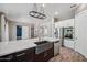 A modern kitchen island featuring a sink, faucet, and stainless steel dishwasher with an open concept design at 422 E Kaibab Pl, Chandler, AZ 85249