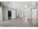 Spacious living room featuring wood-look tile flooring, neutral walls, and a barn door at 422 E Kaibab Pl, Chandler, AZ 85249