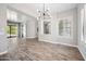 Open concept living room with sliding glass doors, wood-look tile flooring and neutral paint at 422 E Kaibab Pl, Chandler, AZ 85249