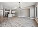 Bright and airy living room featuring an open floorplan, wood-look tile, and modern lighting at 422 E Kaibab Pl, Chandler, AZ 85249