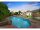Inviting pool surrounded by lush tropical landscaping and a cozy patio, perfect for relaxing evenings at home at 422 E Kaibab Pl, Chandler, AZ 85249