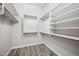 Spacious walk-in closet with custom shelving and wood-look tile floor at 422 E Kaibab Pl, Chandler, AZ 85249
