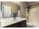 Bathroom with a vanity sink, large mirror, and shower-tub combo with tiled walls at 4705 E Red Oak Ln # 101, Gilbert, AZ 85297