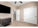 Bedroom with dark wood dresser, sliding-door closet, and neutral carpet at 4705 E Red Oak Ln # 101, Gilbert, AZ 85297