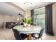 Cozy dining area open to the living room with a modern table and sliding glass door at 4705 E Red Oak Ln # 101, Gilbert, AZ 85297