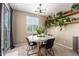 Bright dining room with a glass table, modern chandelier, and plenty of natural light at 4705 E Red Oak Ln # 101, Gilbert, AZ 85297