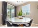 Stylish dining area featuring a round glass table and sliding doors leading to the outdoor space at 4705 E Red Oak Ln # 101, Gilbert, AZ 85297