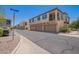 Modern townhome exterior featuring attached garages and vibrant blue shutters and convenient parking at 4705 E Red Oak Ln # 101, Gilbert, AZ 85297