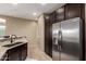 Kitchen featuring stainless steel refrigerator, granite countertops, and dark cabinets at 4705 E Red Oak Ln # 101, Gilbert, AZ 85297