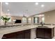 Open concept kitchen with stone countertops, stainless appliances, and breakfast bar at 4705 E Red Oak Ln # 101, Gilbert, AZ 85297