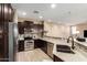 Modern kitchen with stainless steel appliances, dark wood cabinets, and tile backsplash at 4705 E Red Oak Ln # 101, Gilbert, AZ 85297