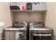 Laundry room with modern front-load washer and dryer and overhead storage shelf at 4705 E Red Oak Ln # 101, Gilbert, AZ 85297