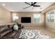 Comfortable living room with a sectional sofa, decorative rug, and entertainment setup at 4705 E Red Oak Ln # 101, Gilbert, AZ 85297