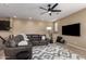 Stylish living room featuring a large sectional sofa, modern ceiling fan, and sleek television at 4705 E Red Oak Ln # 101, Gilbert, AZ 85297