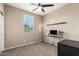 Office space with sleek glass desk, modern lamp, and large window with natural light at 4705 E Red Oak Ln # 101, Gilbert, AZ 85297