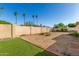 Large backyard with brick border accents and towering palm trees in distance at 5649 W Holly St, Phoenix, AZ 85035