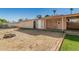 Wide backyard features large block wall, a bonus room, and covered carport at 5649 W Holly St, Phoenix, AZ 85035