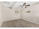 Neutral bedroom with tile flooring, ceiling fan, and ample natural light at 5649 W Holly St, Phoenix, AZ 85035