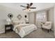 Cozy bedroom with a ceiling fan, neutral decor, and ample natural light at 5649 W Holly St, Phoenix, AZ 85035
