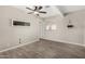 This is a neutral bedroom with tile flooring, a ceiling fan, and a window at 5649 W Holly St, Phoenix, AZ 85035