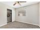 Bedroom features a ceiling fan, window with blinds, and a closet with sliding doors at 5649 W Holly St, Phoenix, AZ 85035
