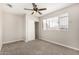 Bedroom with a ceiling fan, window with blinds, and a closet with sliding doors at 5649 W Holly St, Phoenix, AZ 85035