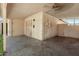Spacious covered carport with metal security doors and overhead light fixture at 5649 W Holly St, Phoenix, AZ 85035