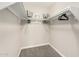 Walk-in closet with multiple shelves, hanging space, and neutral carpeting at 5649 W Holly St, Phoenix, AZ 85035