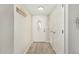Bright entryway with tile floors, coat hooks, and a white door with decorative glass at 5649 W Holly St, Phoenix, AZ 85035