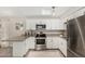 Modern kitchen featuring granite counters, stainless steel appliances, and updated white cabinetry at 5649 W Holly St, Phoenix, AZ 85035