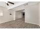 Bright living room with wood-look tile flooring, ceiling fan, and an open floor plan to the next room at 5649 W Holly St, Phoenix, AZ 85035