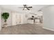 Light-filled living room with tile flooring that opens to a kitchen with stainless steel appliances at 5649 W Holly St, Phoenix, AZ 85035