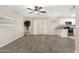 Spacious living room with tile floors, a ceiling fan, and an open layout to the kitchen area at 5649 W Holly St, Phoenix, AZ 85035