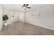Open concept living room featuring tile flooring, a ceiling fan, and lots of natural light at 5649 W Holly St, Phoenix, AZ 85035
