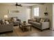 Inviting living room featuring neutral tones, a ceiling fan, and comfortable seating arrangement at 5649 W Holly St, Phoenix, AZ 85035