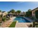 Lush backyard oasis with a sparkling pool and well-manicured desert landscaping at 5649 W Holly St, Phoenix, AZ 85035