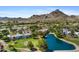 Aerial view of the community, golf course, pond, and scenic mountain views in the background at 6138 N 28Th St, Phoenix, AZ 85016