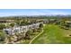 Aerial view showcasing the community, manicured landscaping, golf course, and city skyline in the background at 6138 N 28Th St, Phoenix, AZ 85016