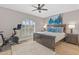 Comfortable bedroom featuring a ceiling fan, exercise bike, and a cozy window seating at 6138 N 28Th St, Phoenix, AZ 85016