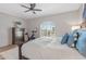 Bright bedroom with a ceiling fan, accent pillows, a large window, and a nearby exercise bike at 6138 N 28Th St, Phoenix, AZ 85016