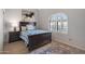 Cozy bedroom with natural light, wood floors, area rug, and decorative arched window at 6138 N 28Th St, Phoenix, AZ 85016