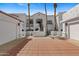 Exterior of the white condo featuring a red brick driveway and a stairway leading up to the front door at 6138 N 28Th St, Phoenix, AZ 85016
