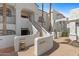 Stairway leading to front door of condo, accented by potted plant and white stucco walls at 6138 N 28Th St, Phoenix, AZ 85016