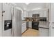 Bright kitchen features stainless steel appliances, white cabinetry, and sleek countertops at 6138 N 28Th St, Phoenix, AZ 85016