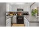 Well-lit kitchen with white cabinets, gray countertops, and modern stainless steel appliances at 6138 N 28Th St, Phoenix, AZ 85016