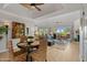 Open-concept living and dining area with a ceiling fan, hardwood floors, and large windows at 6138 N 28Th St, Phoenix, AZ 85016