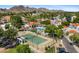 Aerial view of community tennis courts, pool, and beautiful mountain views in the background at 6138 N 28Th St, Phoenix, AZ 85016