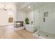 Bright primary bathroom with soaking tub, glass shower, and fireplace at 6439 E Redmont Dr, Mesa, AZ 85215